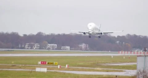 04.04.2024 HAMBURG, DE - Airbus Beluga Landing on Runway at Busy Airport Stock Footage 271211462
