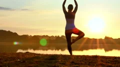 Woman Practising Yoga at Sunrise 4K