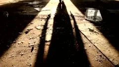 shadow of a killer walking away