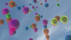 Multi-colored balloons floating in a blue sky