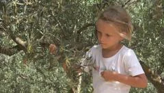Happy Smiling Little Girl Picking Olives in Orchard, View Child, Kid in Nature