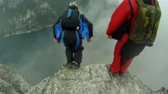 Base jumper jumping of a cliff for an extreme sport