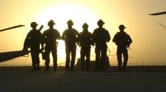 WAR - Soldiers Silhouetted by Sunset in Combat