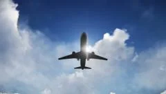Airplane taking off with a sun and clouds background