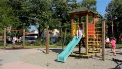 Children playing in the park. Playground. Swing, slide, merry go round. Kids.