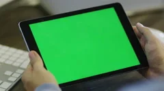 Designer using Digital Tablet with Green Screen at Work in Landscape