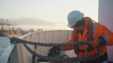 04/19/2020. Black Sea. A worker on a ship pulls a rope aboard the ship. Sailor Video stock 129617751