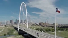 Dallas Skyline aerial with landmark bridge and Texas Flag