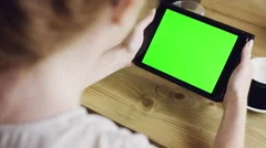 Green screen hands using digital tablet touchscreen device ipad in cafe