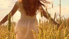 Beauty girl running on yellow wheat field. Happy woman outdoors. Harvest
