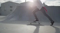 SLOW MOTION: Skateboarder jumps on his skate and starts cruising