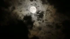 Full Moon in night sky with clouds