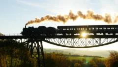 beautiful nostalgic view of steam locomotive train silhouette at sunset sky
