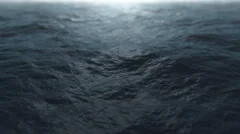 Slow motion fly over stormy ocean water surface
