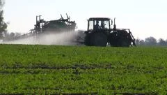 farm tractor spray autumn  green rapeseed crop field