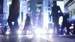crowd of people walking in urban city environment. new york city at night