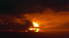 4K flaming sun dramatic sunrise timelapse over mountain clouds light rays
