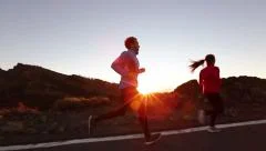 Running sport athletes woman and man jogging - Runners training exercising
