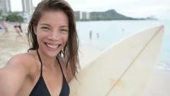 Surfing surfer girl taking selfie withsurfboard