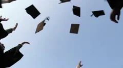 Graduation caps are tossed into the air by a happy asian girls group friends-Dan
