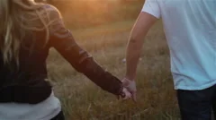 Couple in love walking at sunset. Slow motion