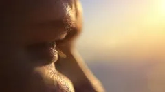Close up of pensive handsome face young men watching sunset by the sea. Enjoying