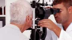Optician examining a patients eyes