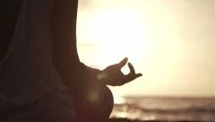 Close Up Hand Of Woman Meditating In a Yoga Pose On The Beach