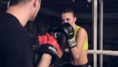Woman Exercising With Trainer At Boxing In Basement