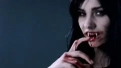 Female vampire killing man smiling