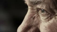 closeup footage on very old man's eyes: thoughtful elderly man