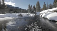 4K - Winter creek with fresh snow and steam in the mountain during winter
