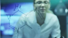 Woman Scientist is Drawing Organic Chemical Formulas on Glass