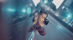 Girl leaning out of car window while driving