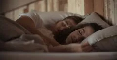 Young sleeping couple in bed