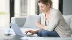 Middle-aged woman working from home on laptop computer
