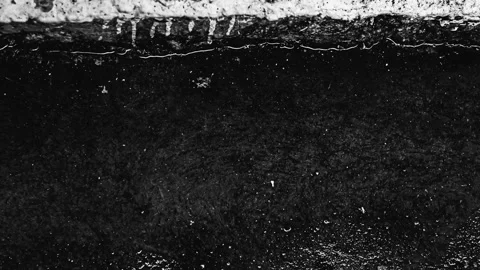 048_Close up of black asphalt texture.mp4 Stockbeeldmateriaal 345726305