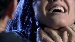 Closeup of hand strangling and hitting woman domestic violence
