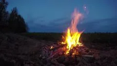 evening landscape - beautiful campfire bonfire on field. 4K