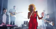 4K Beautiful charismatic female singer performing with band at live music event