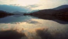 Aerial Drone footage of lake and mountains against sky