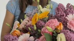 Florist makes a huge beautiful colorful bouquet composed of various flowers
