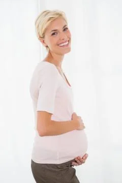 Portrait of smiling blonde pregnant with white background xkwx 20s, Young Adult, Woman, Female, Caucasian, Home, House, Household, Homey, Apartment, Domicile, Abode, Lifestyle, Leisure, Domestic Life, Casual Clothing, Pregnancy, Expecting, Pregnant, Belly, Maternity, Holding, Touching, Anticipation, Calm, Peaceful, Relaxing, Content, Happy, Smiling, Cheerful, Fair Hair, Blonde, Light Hair, Short Hair, Indoors, BABYP5BRIEF