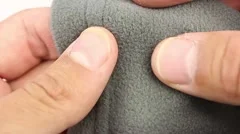 human hand testing fleece thermal underwear, closeup, the tensile test
