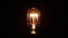 Light bulb closeup with bright turns on/off fast and slow