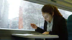 4k, young businesswoman planning for meeting on early morning commuter train