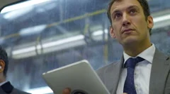 4k, Attractive businessman working on digital tablet on city underground train