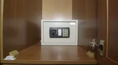 Man using the keypad of safe box mounted in wardrobe