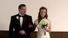 Shot in front of a father and bride walking down the aisle.