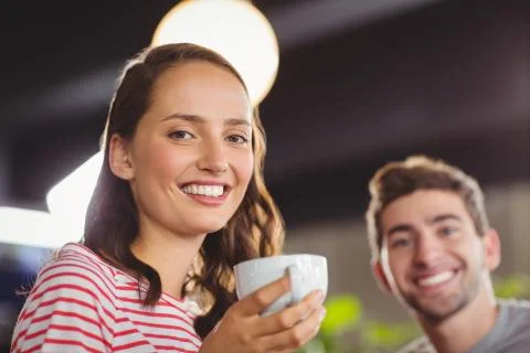 Portrait of smiling friends enjoying coffee together at coffee shop xkwx 20s, Young Adult, Man, Male, Caucasian, Woman, Female, Shop, Cafe, Coffee, Business, Coffee Shop, Cafeteria, Restaurant, Food And Drink Industry, Food, Lifestyle, Leisure, Coffee House, Weekend Activities, Relaxing, Time Off, Drinking, Holding, Cup, Mug, Beverage, Strong, Hot, Caffeine, Dark, Americano, Espresso, Break, Friends, Casual, Hipster, Hipsters, Happy, Smiling, Cheerful, Plants, Portrait, Indoors